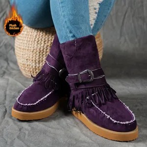 Detail view of purple suede snow boots featuring fringe design and decorative metal buckle