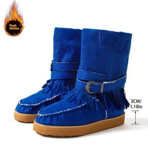 Detailed view of vibrant blue suede snow boots with fringe and a 3cm thick rubber sole