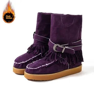 Detailed shot of purple suede fringe boots featuring a decorative buckle and plush lining