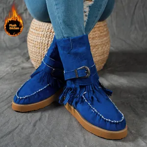 Detailed view of royal blue fringe snow boots with plush lining and platform sole.