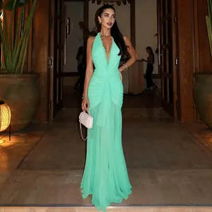 Full view of the elegant mint green halter neck pleated mesh maxi dress on a female model