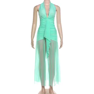 Elegant mint green halter neck dress with ruched bodice and sheer mesh skirt panels.