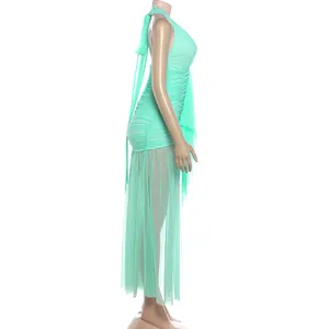 Detailed side profile of a mint green halter neck ruched dress with sheer mesh hemline