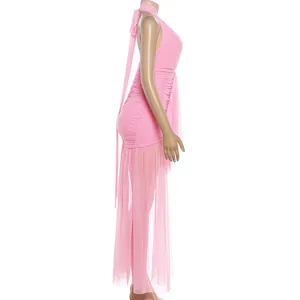 Detailed side view showing the mesh and ruched textures of this pink halter dress.