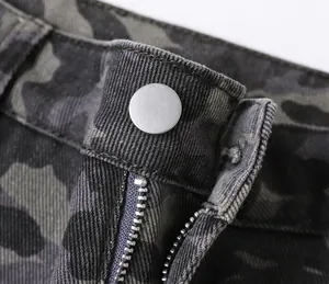 Close-up of metal button and zipper on men's camouflage cargo jeans