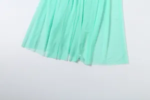 Macro view of mint green mesh fabric with delicate pleats for an elegant dress