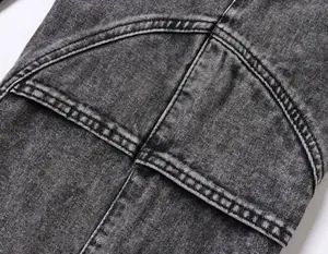 Close-up of durable stitching and washed denim fabric on retro cargo pants