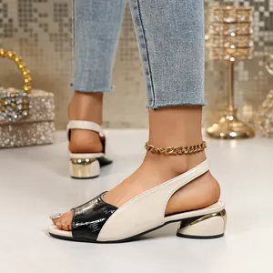 Close-up view of two-tone slingback sandals featuring a fish mouth toe and metallic block heel