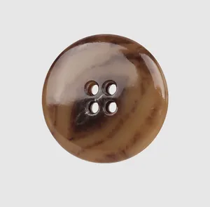 Macro detail of a brown marbled four-hole urea button for high-end clothing.
