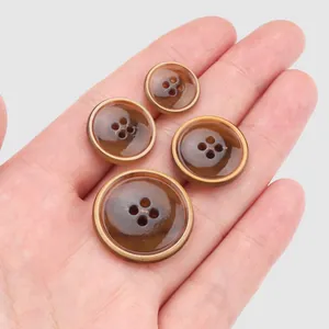 Set of four gradient brown urea buttons in various sizes for sewing