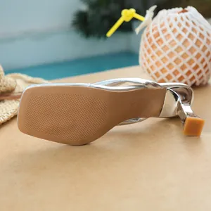 Close-up detail of the anti-slip sole and heel of a silver square toe thong high heel sandal