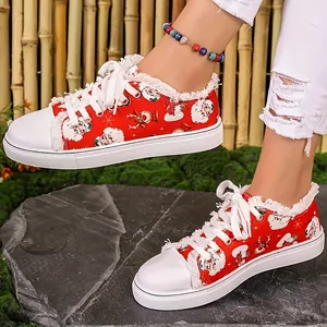 Close-up detail of women's red Christmas sneakers featuring festive Santa Claus prints