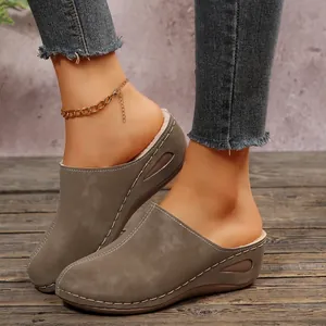 Detail of warm women's mules featuring fleece lining and contrast stitching design.