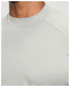 Close-up detail of a light gray breathable men's sports t-shirt neck and raglan sleeve