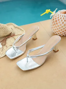 Silver square toe thong high heel sandals displayed in a tropical beach poolside setting