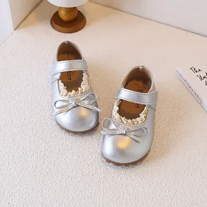 Detailed view of silver girls' toddler princess shoes featuring lace trim and bow accent