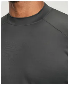 Close-up of the neckline and raglan sleeve detail on a dark grey athletic t-shirt.