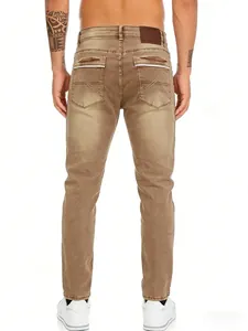Detailed back view of men's distressed tan jeans showing unique pocket stitching