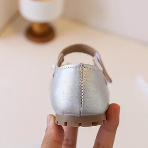 Detailed close-up of silver leather toddler girl shoe heel with anti-slip rubber sole
