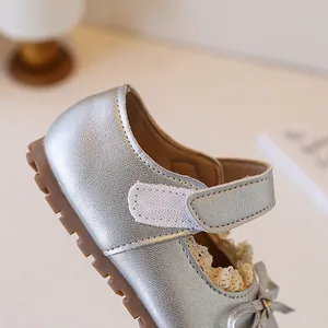 Close-up of silver girls' princess shoe featuring elegant lace trim and secure velcro strap