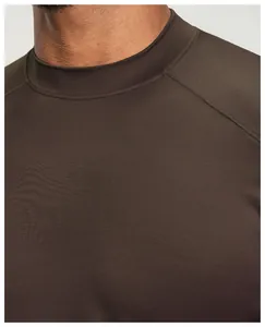 Close-up detail of a dark brown men's athletic t-shirt showing collar and fabric texture