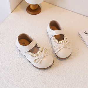 Elegant cream girls' Mary Jane shoes with delicate lace trim and bow detailing