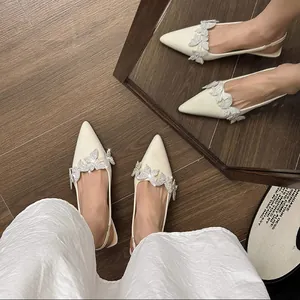 Top view of elegant pointed-toe slingback heels with rhinestone butterfly decor