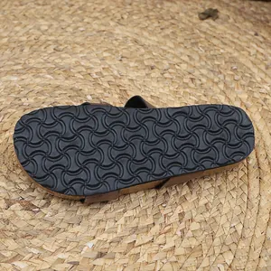 Detail view of the durable non-slip patterned rubber sole on a comfortable cork sandal.