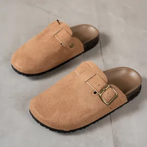 Detailed view of brown suede clogs with adjustable bronze buckle strap and cork sole