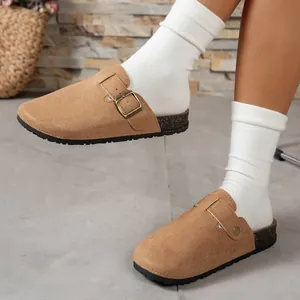 Detailed view of camel suede Boston clogs with adjustable buckle and cork sole