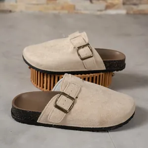 Detailed view of beige suede closed-toe mule sandals with adjustable metal buckle strap