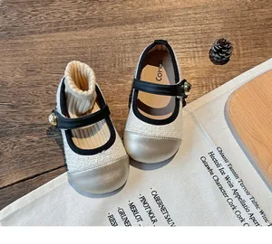 Close-up of beige toddler girls' Mary Jane shoes with gold accents and soft soles