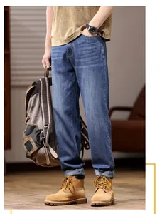 Detailed view of men's loose stretch straight-leg denim jeans in classic blue wash style