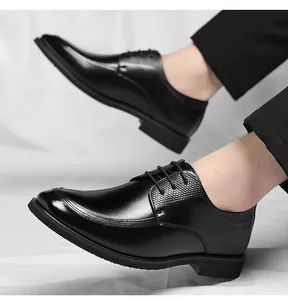 Detail view of black lace-up business leather shoes with textured sides for men.
