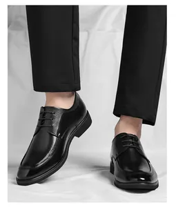 Close-up of black lace-up men's formal leather dress shoes with textured side detail