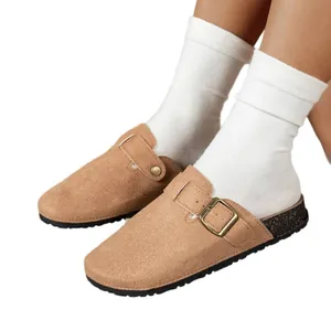 Comfortable women's tan suede clog sandals with buckle detail and cork textured sole