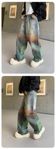 Close-up detail of rainbow gradient dye and paint splatters on wide-leg denim pants