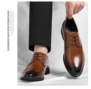 Detail view of brown men's lace-up leather dress shoes with gradient toe design