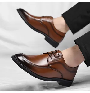 Close-up of men's brown leather business dress shoes with embossed textures and laces