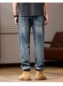 Back view of men's loose straight leg blue denim jeans made from elastic fabric.