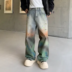 Trendy loose straight-leg jeans with vibrant rainbow gradient dye and washed finish.