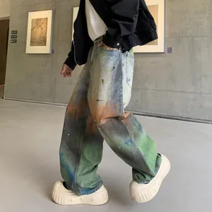 Loose straight-leg washed denim jeans featuring a colorful rainbow ombre tie-dye effect