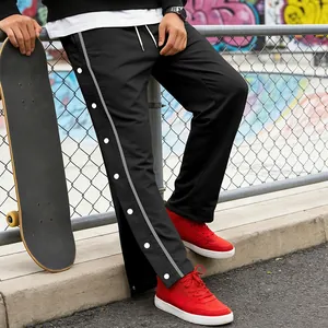 Close-up van zwarte streetwearbroek met drukknopen en strepen op de zij