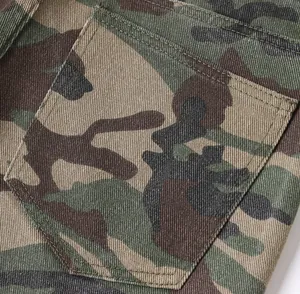 High-quality macro detail of the back pocket on these camouflage patterned denim cargo pants
