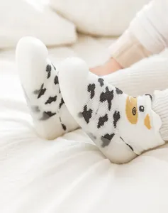 Close-up detail of baby walker shoes featuring a cow pattern and soft non-slip soles