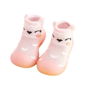 Pink baby walker sock shoes with cute cartoon face and soft non-slip rubber soles