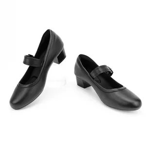 Close-up detail of stylish black round-toe Mary Jane shoes with block heels and straps.