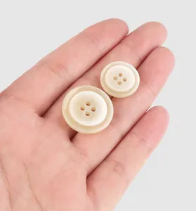 Macro view of high-end off-white resin buttons with four holes for apparel decoration