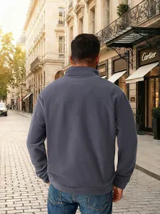 Πίσω όψη ανδρικού γκρι φούτερ fleece με μισό φερμουάρ σε ένα καθημερινό σκηνικό δρόμου