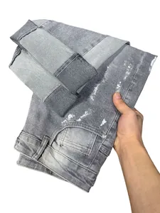 Jeans grigi stile high street con schizzi di vernice bianca e dettaglio strappi